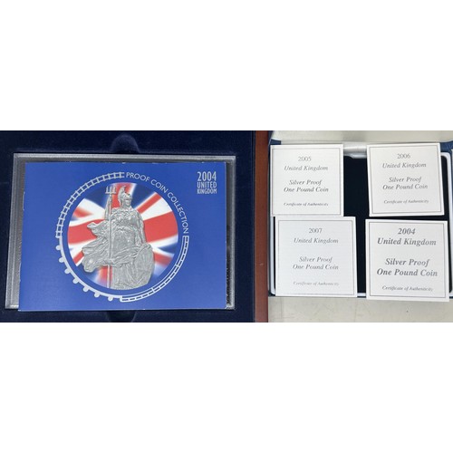 71 - A Royal Mint Executive Proof Coin set, 2004, and four silver proof £1 coins (both boxed)