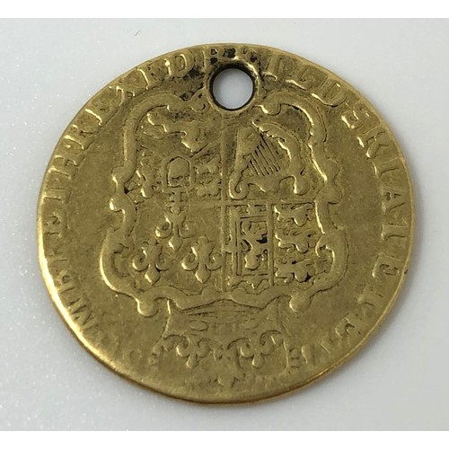 93 - A George III gold half guinea, possibly 1766, worn, drilled