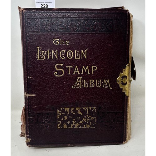 229 - A large Lincoln stamp album, with a brass clasp, binding poor, pages loose