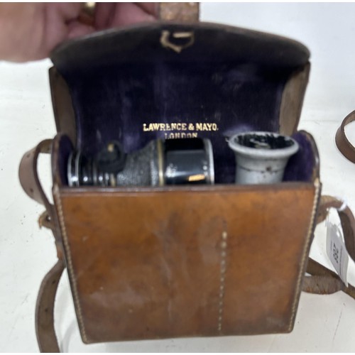 288 - A monocular, and a pair of small field glasses, in a leather case, the inside stamped Lawrence &... 