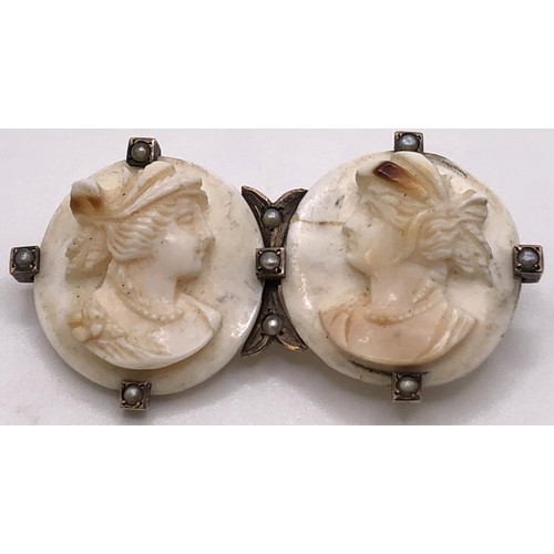 798 - A late 19th/early 20th century double cameo brooch, decorated portraits