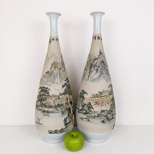 559 - A pair of Chinese stoneware vases, decorated landscapes, 54 cm high