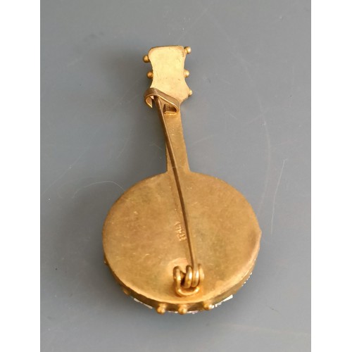 708 - A micro-mosaic brooch, in the form of a banjo, a plated vesta, in the form of a cello and three silv... 