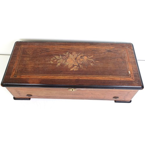 535 - An eight air music box, in a rosewood case, 50 cm wide