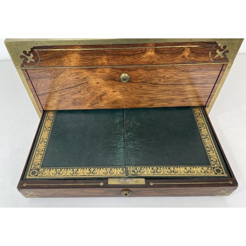 554 - A 19th century rosewood and brass bound jewellery box, the hinged top to reveal a mirror and two fit... 