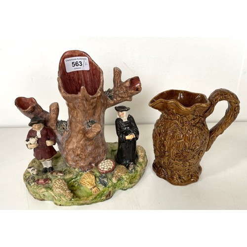 563 - A 19th century Staffordshire Pig Tithe pottery group, 15 cm high, and a harvest jug, 16 cm high (2)