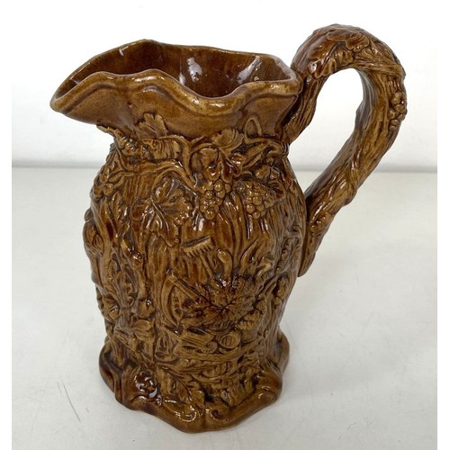 563 - A 19th century Staffordshire Pig Tithe pottery group, 15 cm high, and a harvest jug, 16 cm high (2)