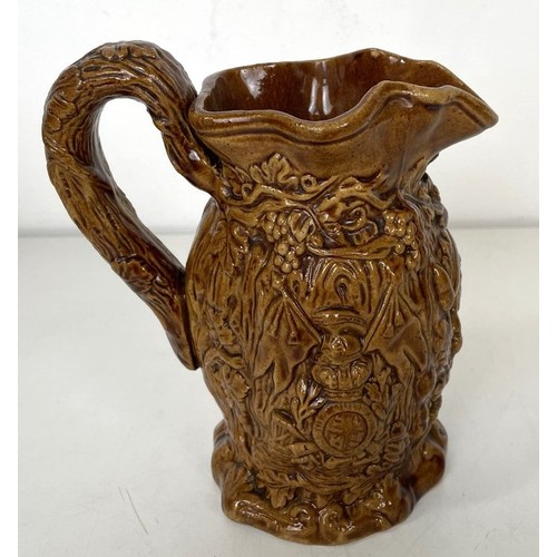 563 - A 19th century Staffordshire Pig Tithe pottery group, 15 cm high, and a harvest jug, 16 cm high (2)