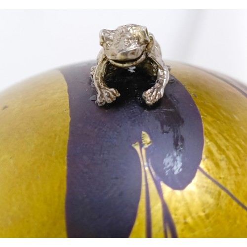 658 - A glass paperweight, applied a silver coloured metal frog, and another (2)