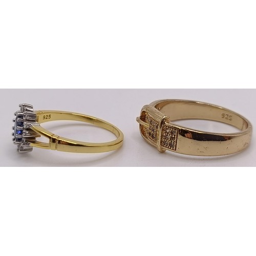 750 - A gilt metal and white stone belt ring, and a silver gilt and gem set ring (2)