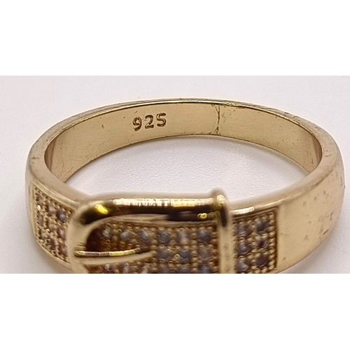 750 - A gilt metal and white stone belt ring, and a silver gilt and gem set ring (2)