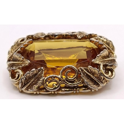 752 - A 20th century gilt metal and amber coloured stone brooch