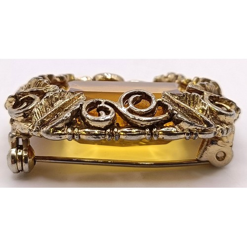 752 - A 20th century gilt metal and amber coloured stone brooch