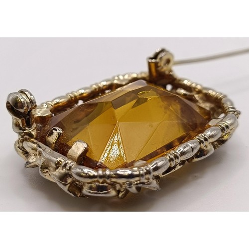 752 - A 20th century gilt metal and amber coloured stone brooch