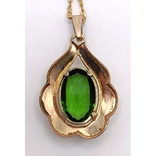 765 - A rolled gold and green stone pendant, on a gilt metal chain