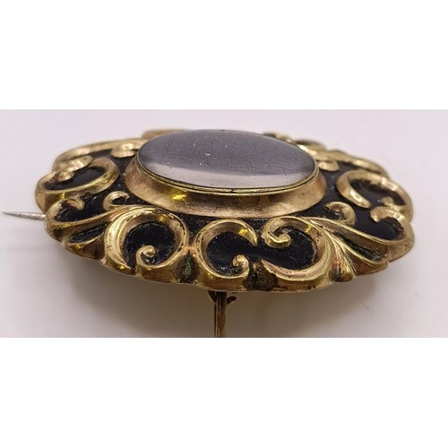 767 - A Victorian gilt metal mourning brooch