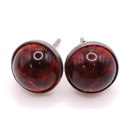 769 - A pair of silver and amber stud earrings, a similar ring, an amber coloured stone pendant (3)