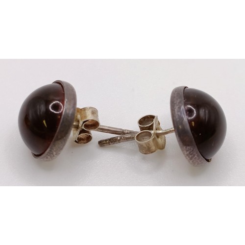 769 - A pair of silver and amber stud earrings, a similar ring, an amber coloured stone pendant (3)