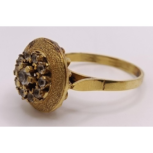 797 - A gilt metal and white stone ring, and a gold plated flower brooch (2)