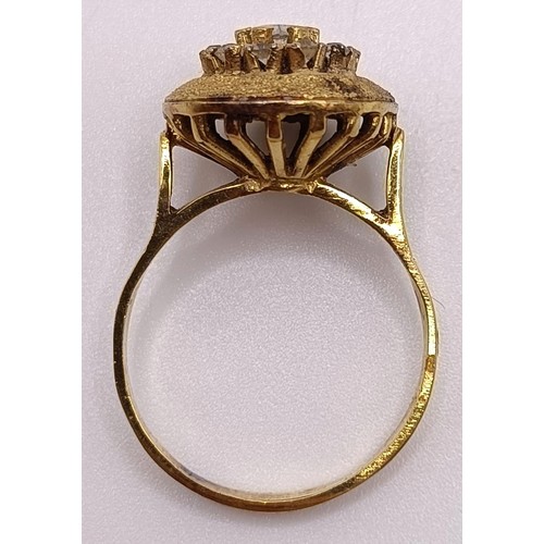 797 - A gilt metal and white stone ring, and a gold plated flower brooch (2)