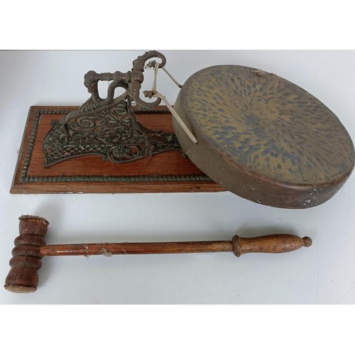 574 - A wall mounted gong, 26 cm diameter, an associated hammer, and a mahogany writing box