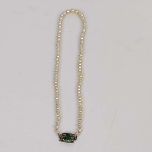 824 - A cultured pearl necklace, with a silver and green stone clasp