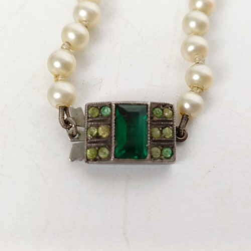 824 - A cultured pearl necklace, with a silver and green stone clasp