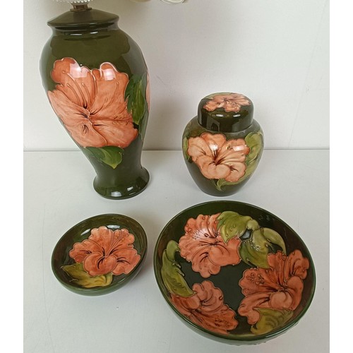 581 - A Moorcroft lamp, decorated flowers, a ginger jar, and two bowls (4)