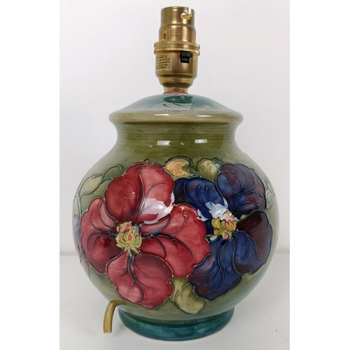 582 - A Moorcroft lamp, decorated flowers, 16 cm high, and a pin dish (2)