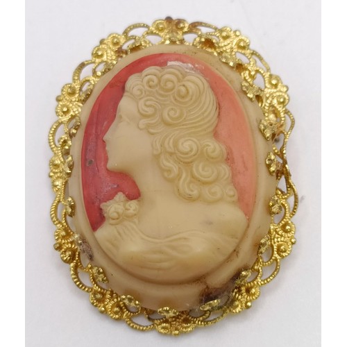 839 - A cameo brooch, decorated a lady, a rolled gold bangle, and a cameo style brooch (3)