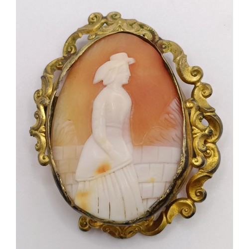 839 - A cameo brooch, decorated a lady, a rolled gold bangle, and a cameo style brooch (3)