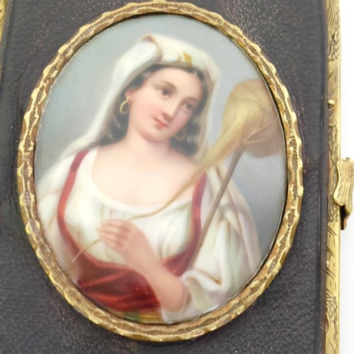 841 - A Victorian leather and brass purse, of rounded rectangular form, applied an oval porcelain plaque, ... 