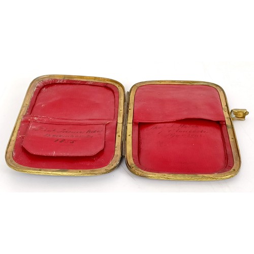 841 - A Victorian leather and brass purse, of rounded rectangular form, applied an oval porcelain plaque, ... 