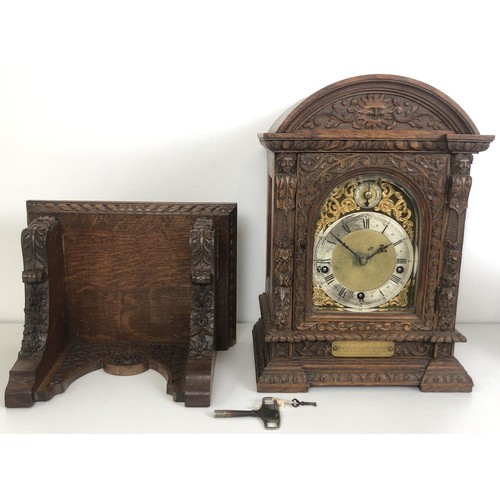 850 - A bracket clock, with a brass dial and an eight day movement, striking on chimes, in a carved oak ca... 