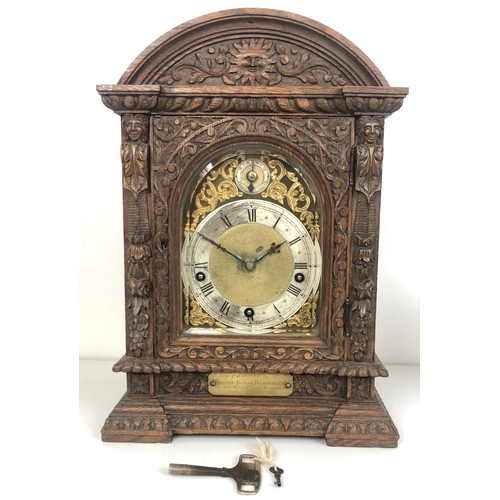 850 - A bracket clock, with a brass dial and an eight day movement, striking on chimes, in a carved oak ca... 