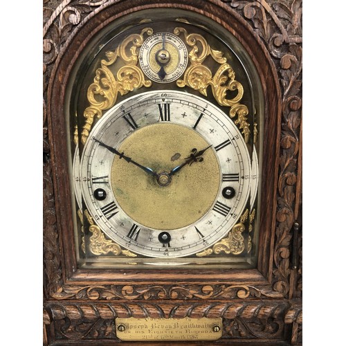 850 - A bracket clock, with a brass dial and an eight day movement, striking on chimes, in a carved oak ca... 