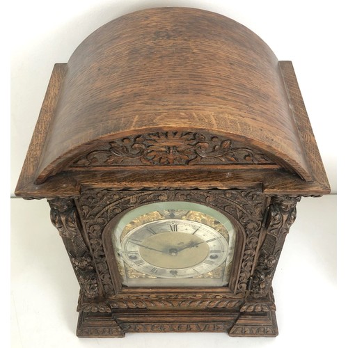 850 - A bracket clock, with a brass dial and an eight day movement, striking on chimes, in a carved oak ca... 