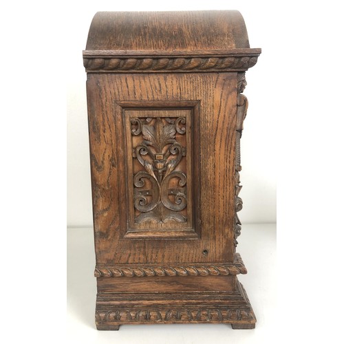 850 - A bracket clock, with a brass dial and an eight day movement, striking on chimes, in a carved oak ca... 