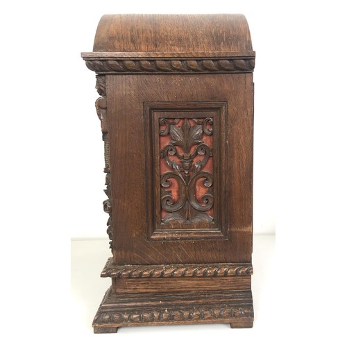 850 - A bracket clock, with a brass dial and an eight day movement, striking on chimes, in a carved oak ca... 