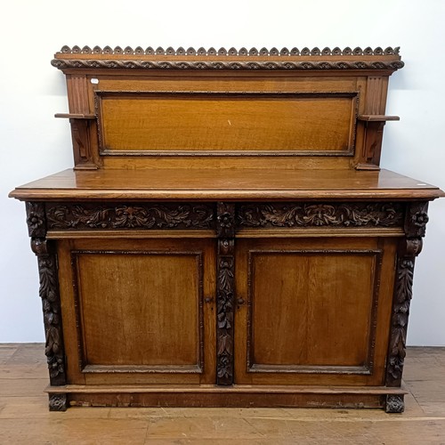 910 - A Victorian oak buffet, with a raised back, on a base with two drawers and two cupboard doors, 153 c... 