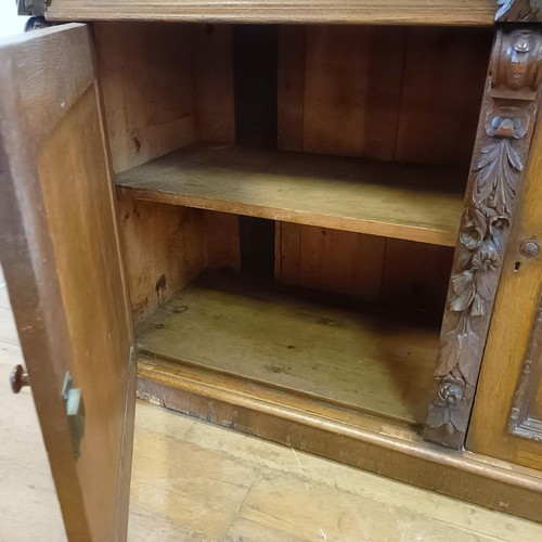 910 - A Victorian oak buffet, with a raised back, on a base with two drawers and two cupboard doors, 153 c... 