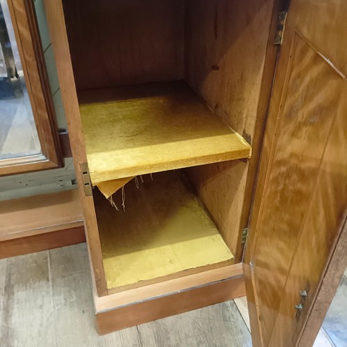 915 - A 19th century satin birch cheval mirror, flanked by two cupboards, 160 cm wide