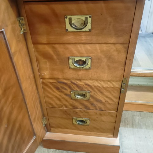 915 - A 19th century satin birch cheval mirror, flanked by two cupboards, 160 cm wide