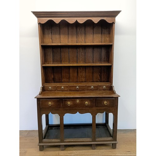 923 - A 19th century oak dresser, on legs joined by a potboard base, 117 cm wide