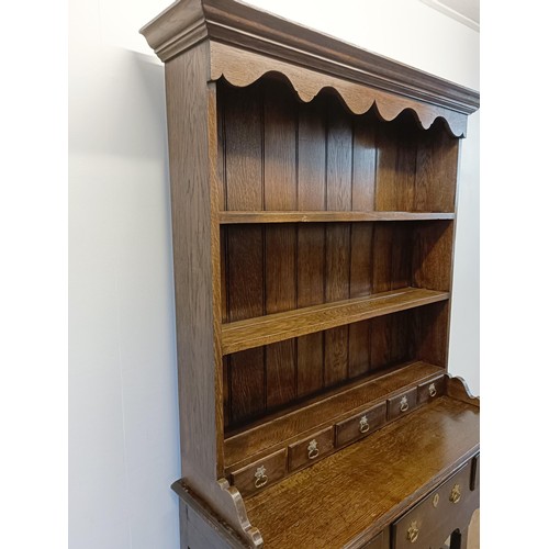 923 - A 19th century oak dresser, on legs joined by a potboard base, 117 cm wide