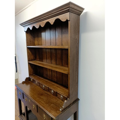 923 - A 19th century oak dresser, on legs joined by a potboard base, 117 cm wide