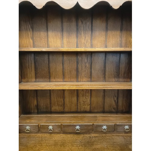 923 - A 19th century oak dresser, on legs joined by a potboard base, 117 cm wide