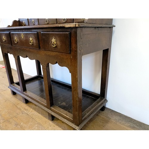 923 - A 19th century oak dresser, on legs joined by a potboard base, 117 cm wide