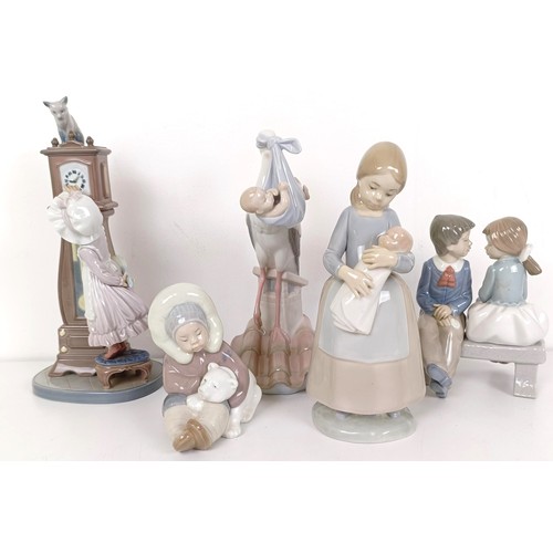 596 - A Lladro figure of a girl cleaning a longcase clock, with a cat on top of the clock, two other Lladr... 