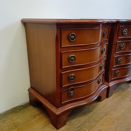 928 - A pair of modern mahogany serpentine front bedside chests, having four drawers, 43 cm wide